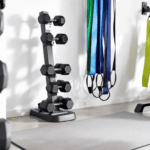 In this image, a home gym setup features a variety of equipment including dumbbells, resistance bands, and an exercise mat, all arranged to facilitate strength training. This environment promotes muscle development and helps combat age-related muscle loss, making it ideal for older adults looking to build muscle mass and enhance their overall health.